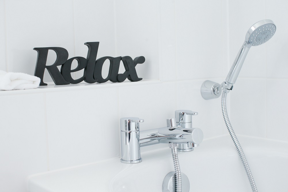 Bath taps with relax sign above