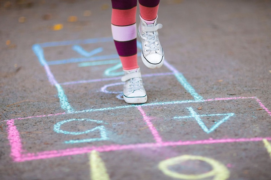 Child's feet playing hopscotch