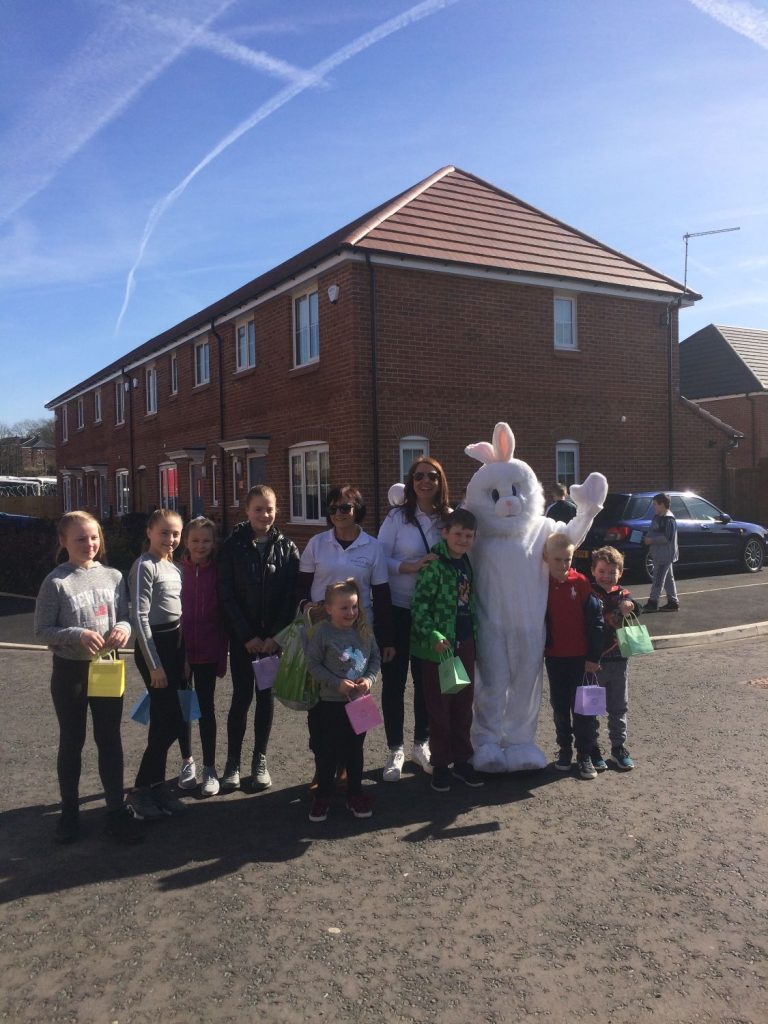 Children post with giant Easter bunny