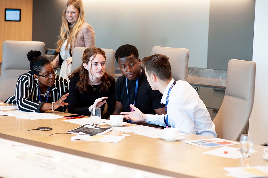 Young people in discussion around a table