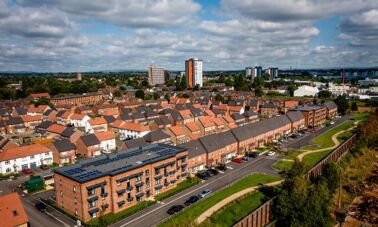 Aerial shot of apartment block and houses