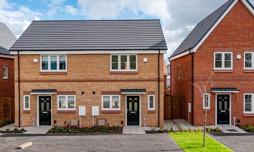 semi detached houses in yellow brick with driveways and lawned area