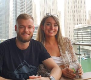 photo of man and woman with skyscrapers behind