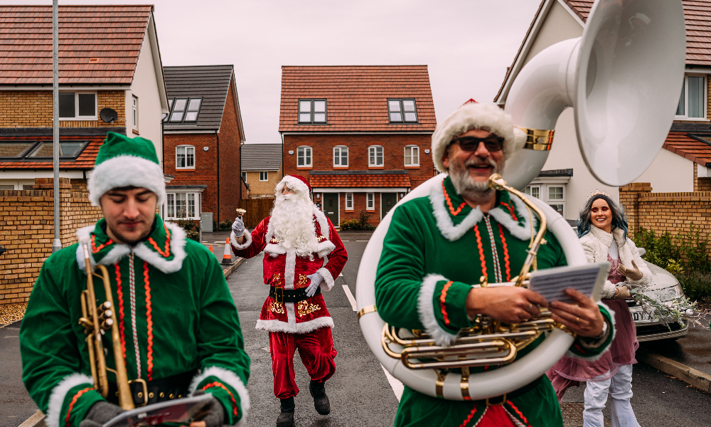 Santa Claus and two Elves with brass band instruments