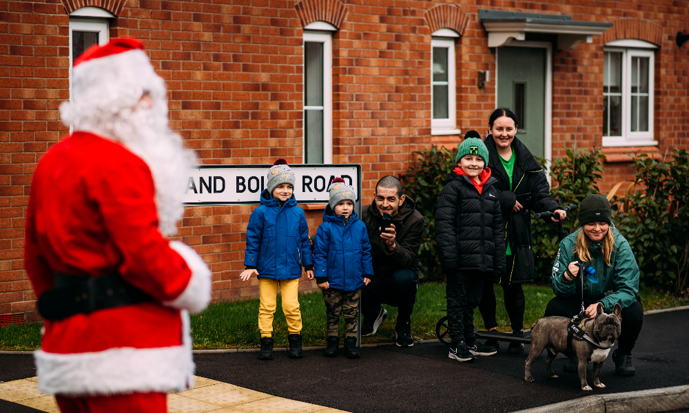 children watch Santa next to a street sign
