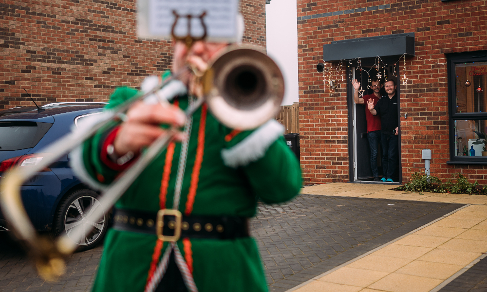 Men watch a trumpeting elf