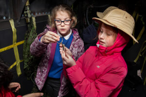 two children look curiously at an object