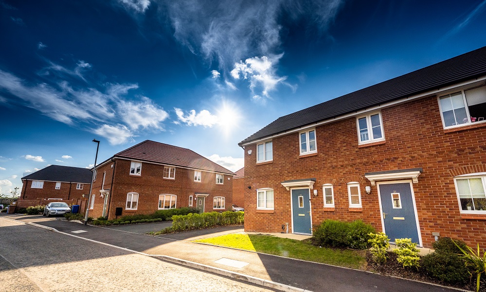 semi detached houses with blue doors in sunshine