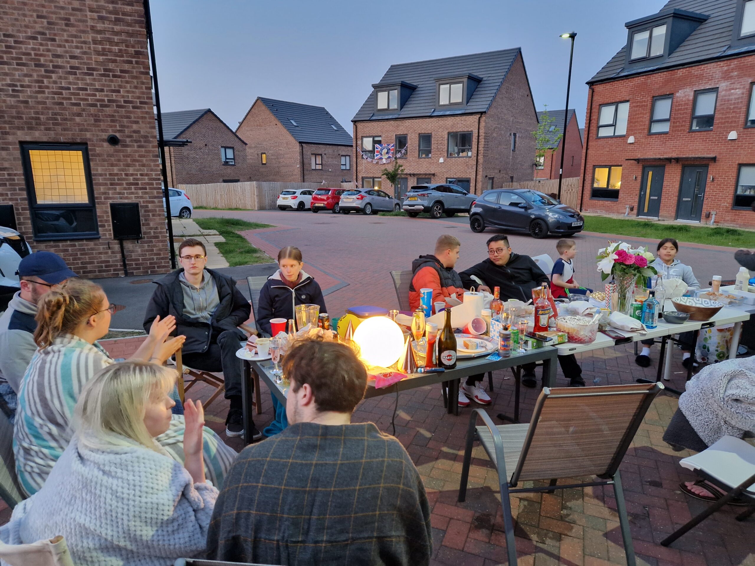 A group of people having a street party at sunset