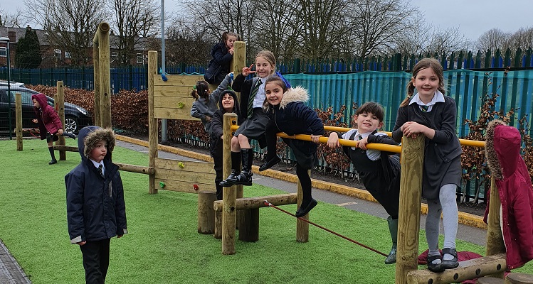 Children playing on a wooden climbing frame