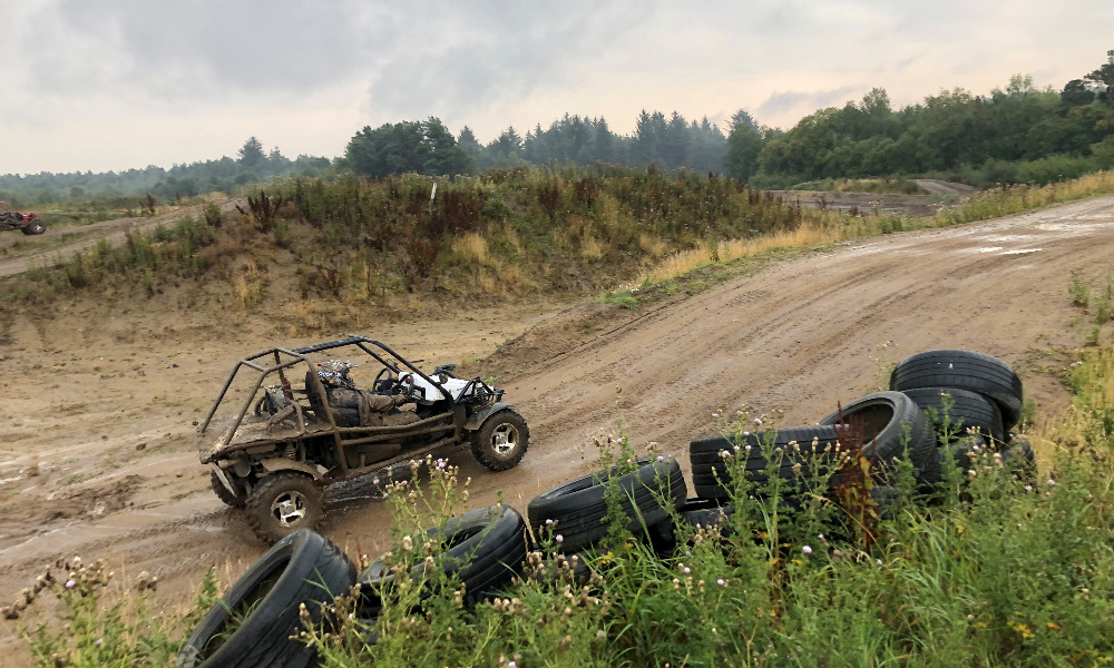 quad bike moving up a dirt hill