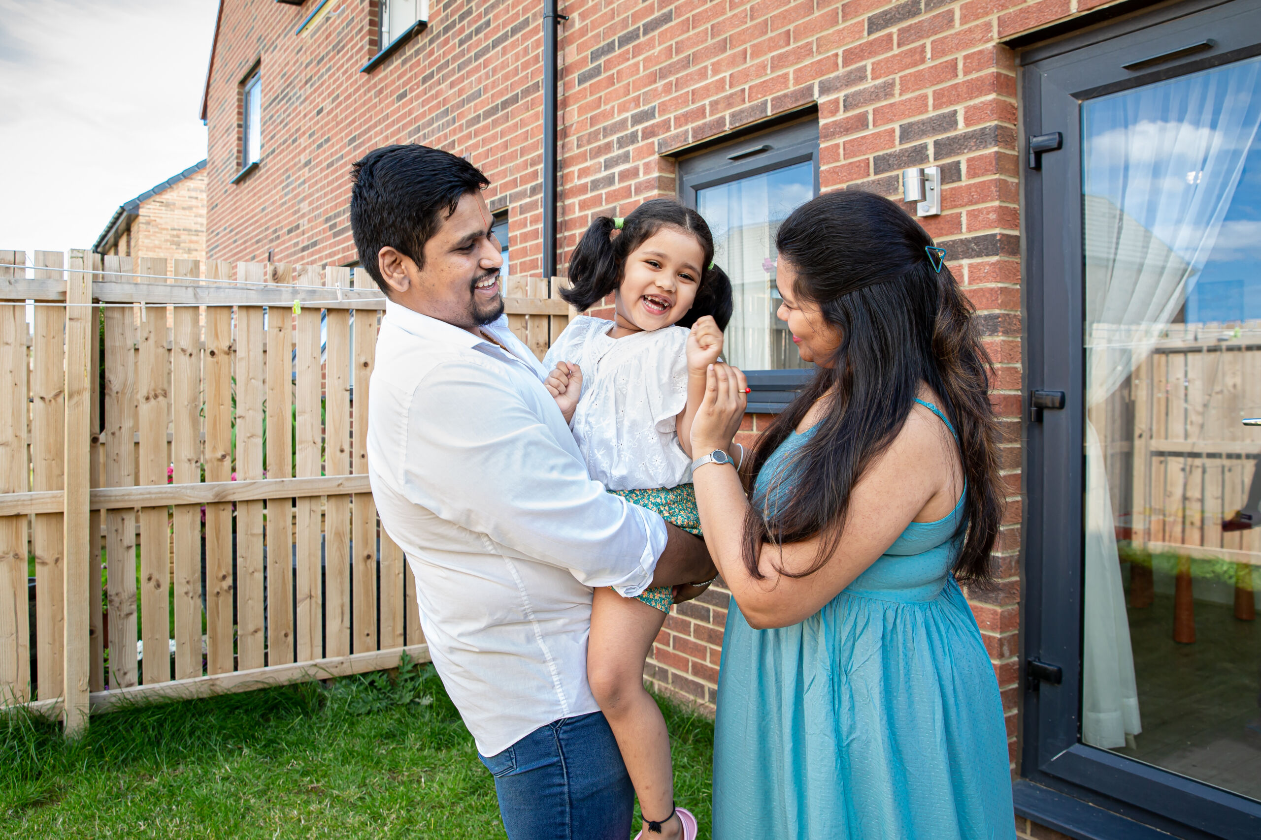 Family outside Simple Life House