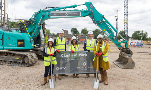 5 people posing for picture during Clapham Park construction