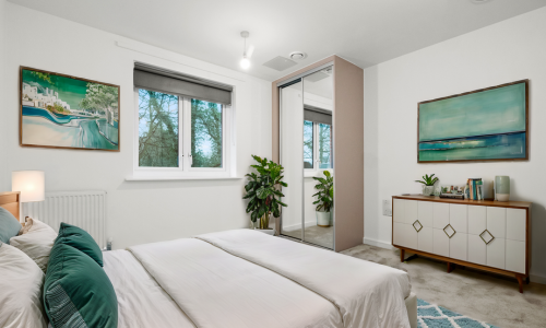 furnished bedroom with mirrored fitted wardrobe