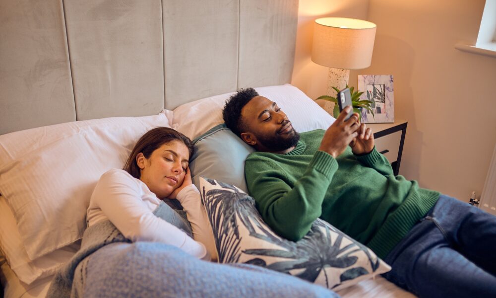 man and woman relaxing in bed