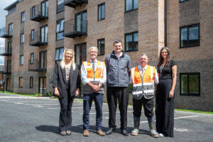 Kellen homes and simple life homes crew Infront of flats