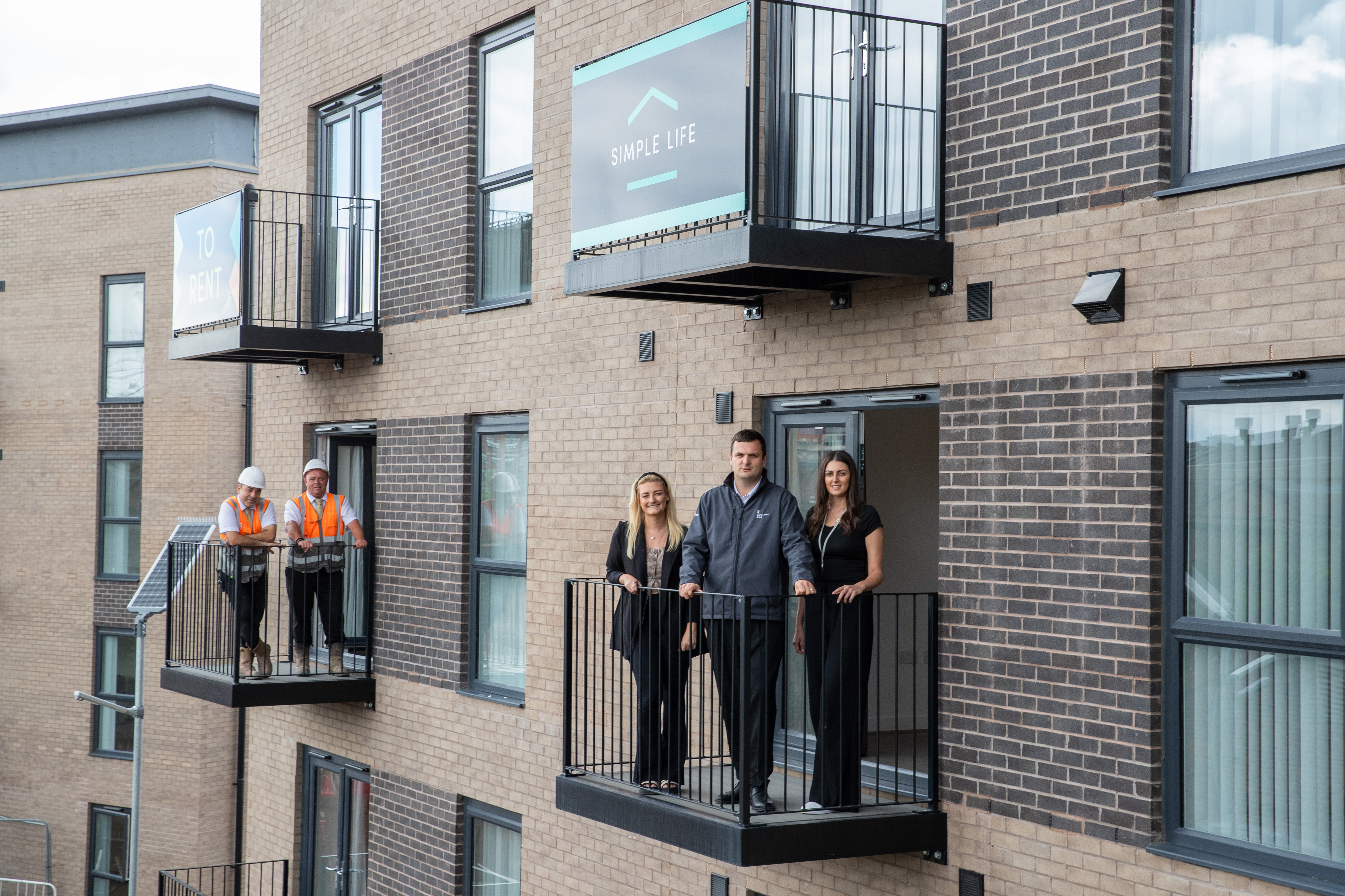 Kellen homes and simple life homes crew on flat balcony's