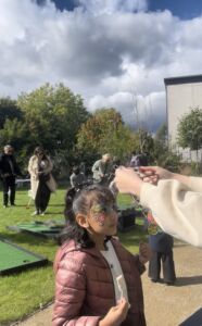 child with face painted getting a little medal