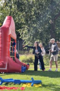 people enjoying an inflatable game