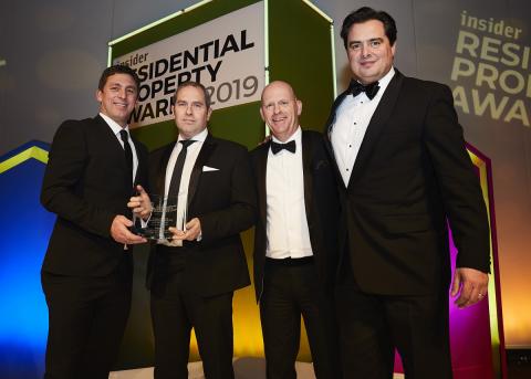 4 men posing for a picture after receiving award