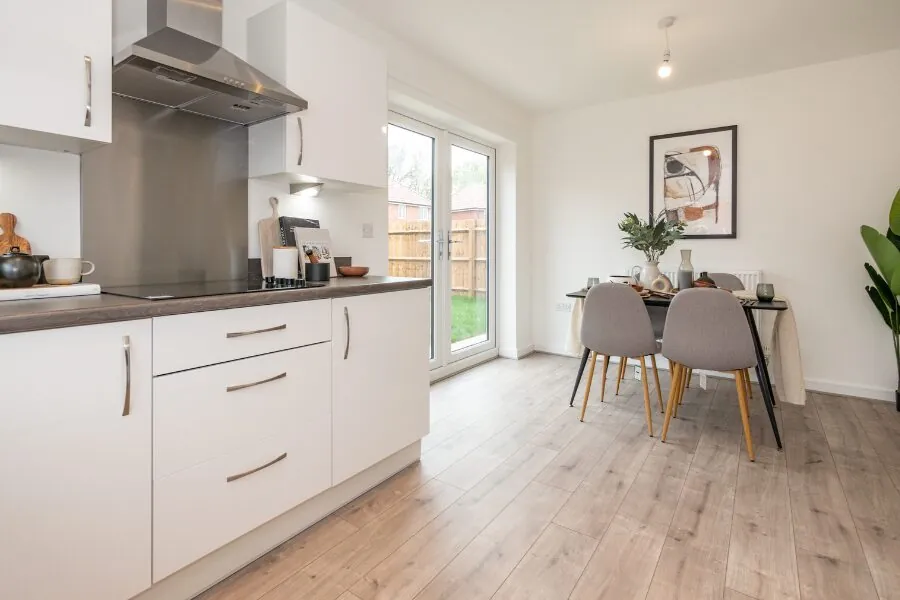 fitted white kitchen and dining area