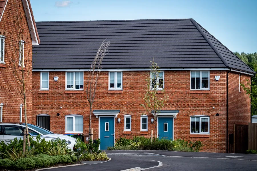 photograph of two semi-detached houses with blue front doors