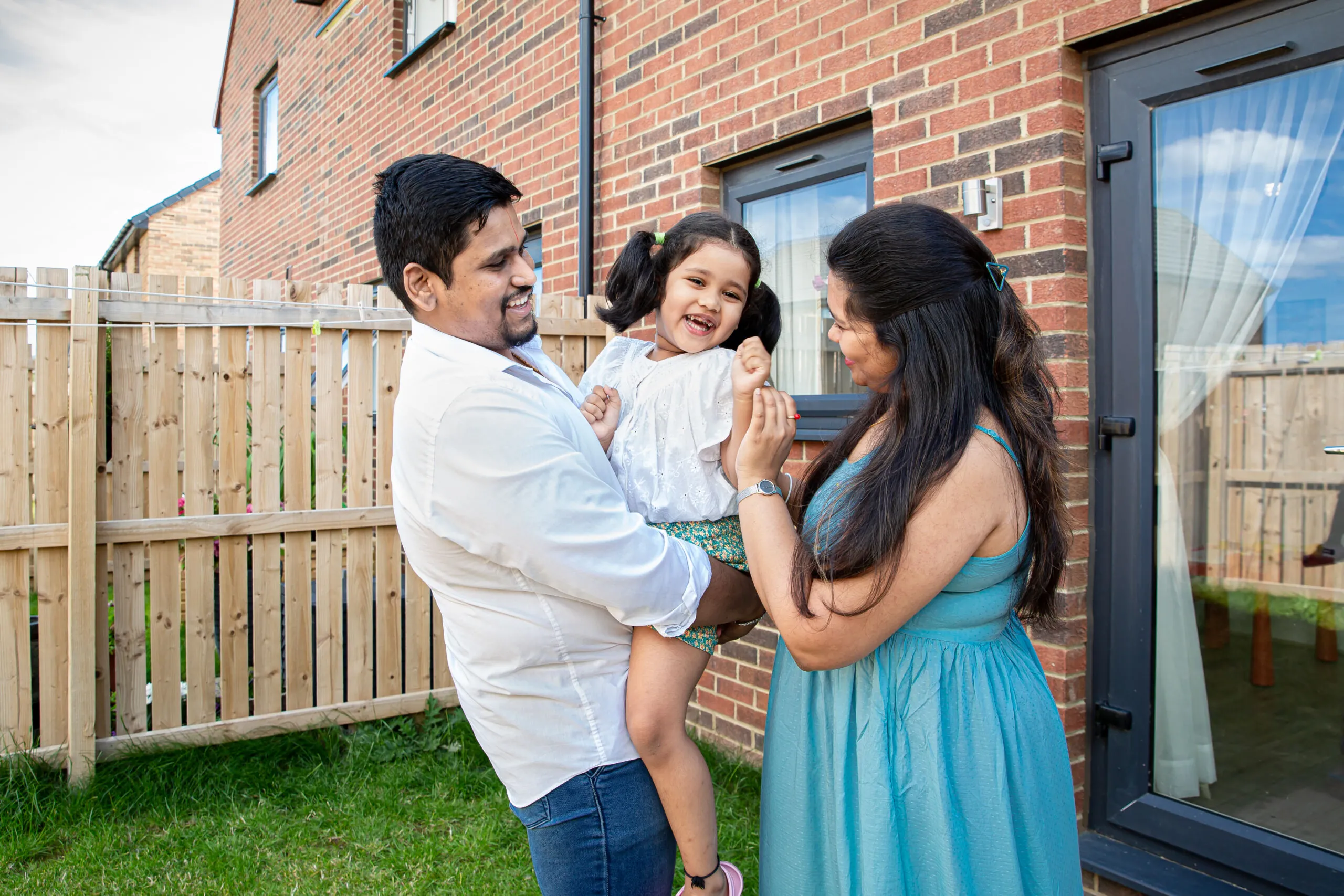 Family outside Simple Life House