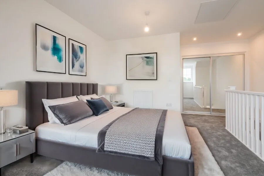 carpeted main bedroom with a white fitted wardrobe