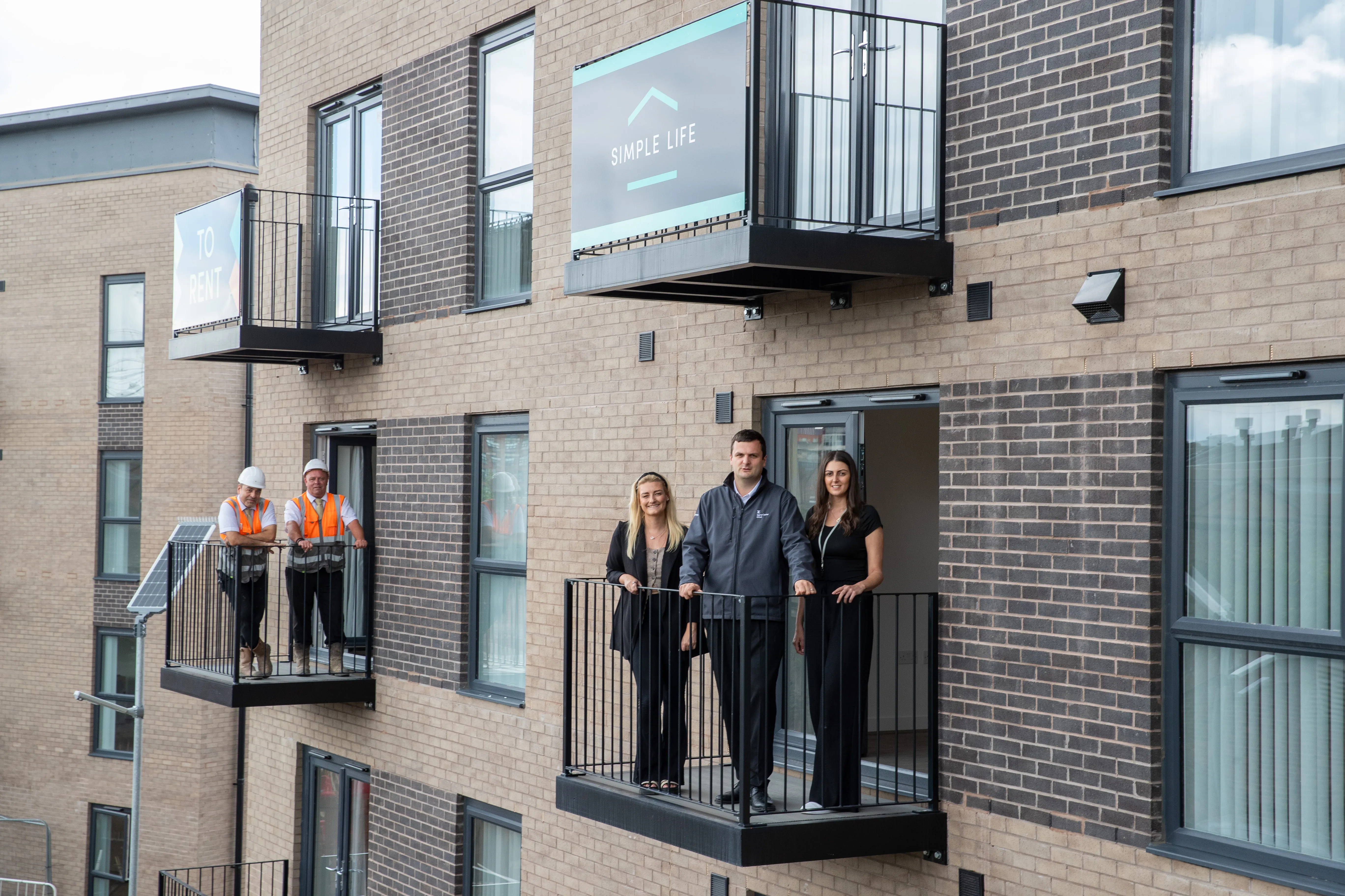 Kellen homes and simple life homes crew on flat balcony's